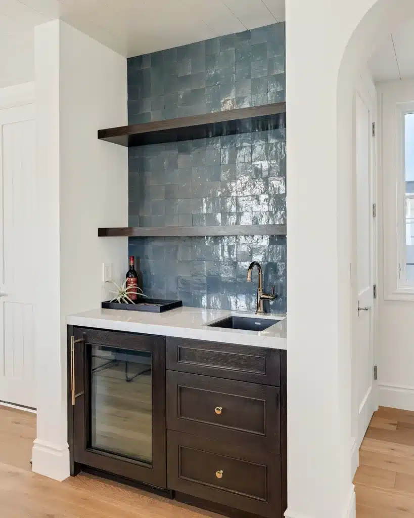 Wet bar with blue zellige tile, dark oak cabinetry and a built-in wine fridge