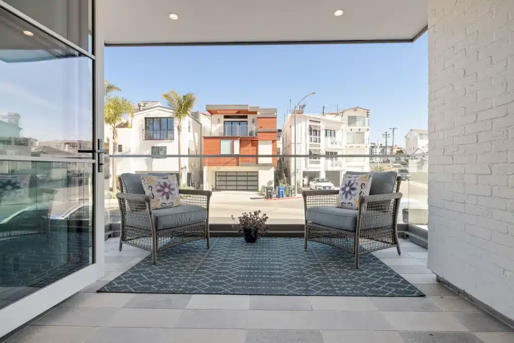 Covered balcony with lounge chairs overlooking the street