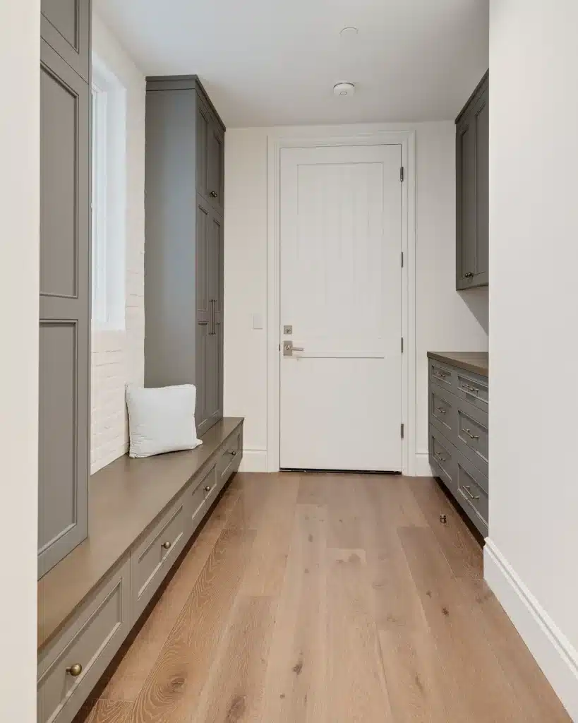 Mudroom with a built-in bench and floor-to-ceiling storage cabinetry