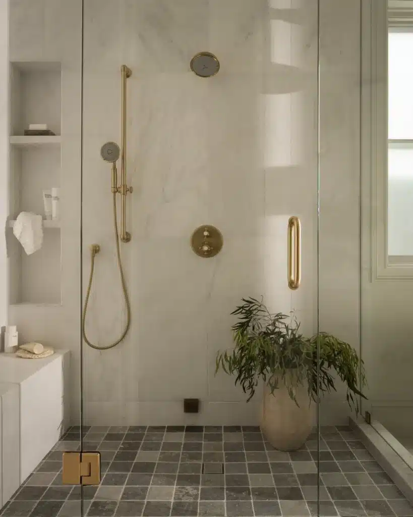Walk-in shower with brass fixtures in a Manhattan Beach remodel