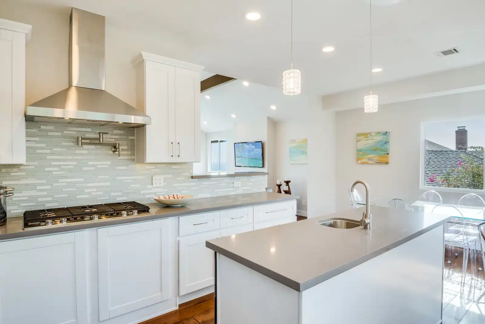 New kitchen with white cabinets and gas range in the remodeled Rancho Palos Verdes home
